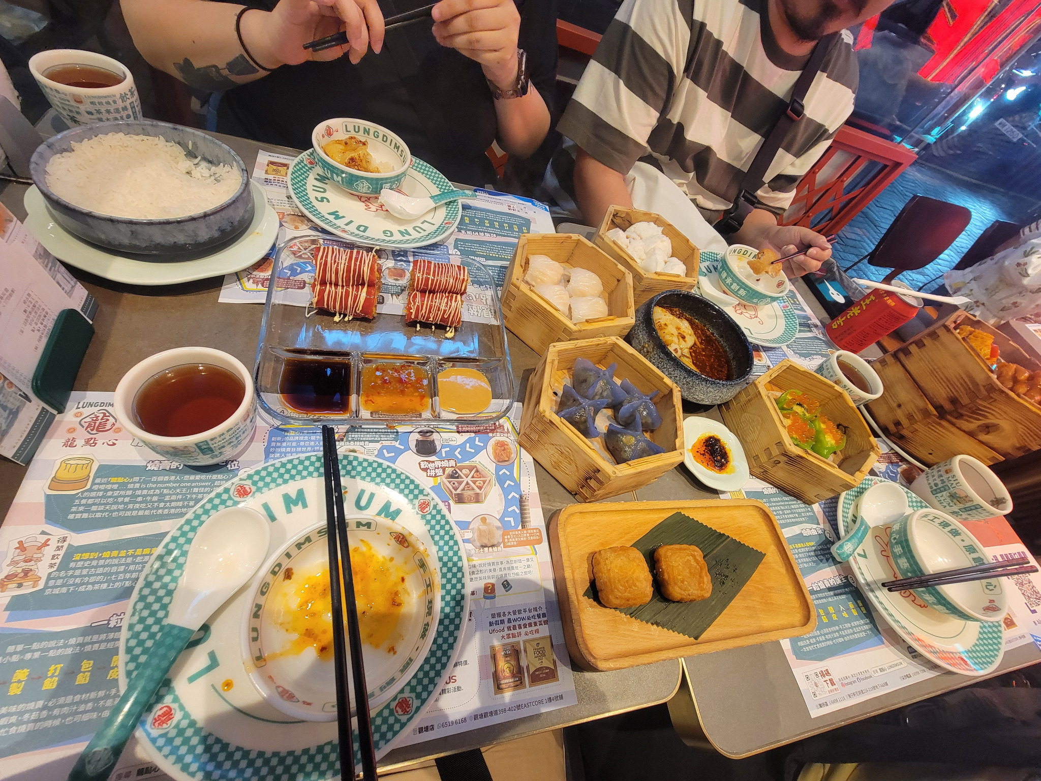 Dim sum spread with bamboo baskets and sauces.