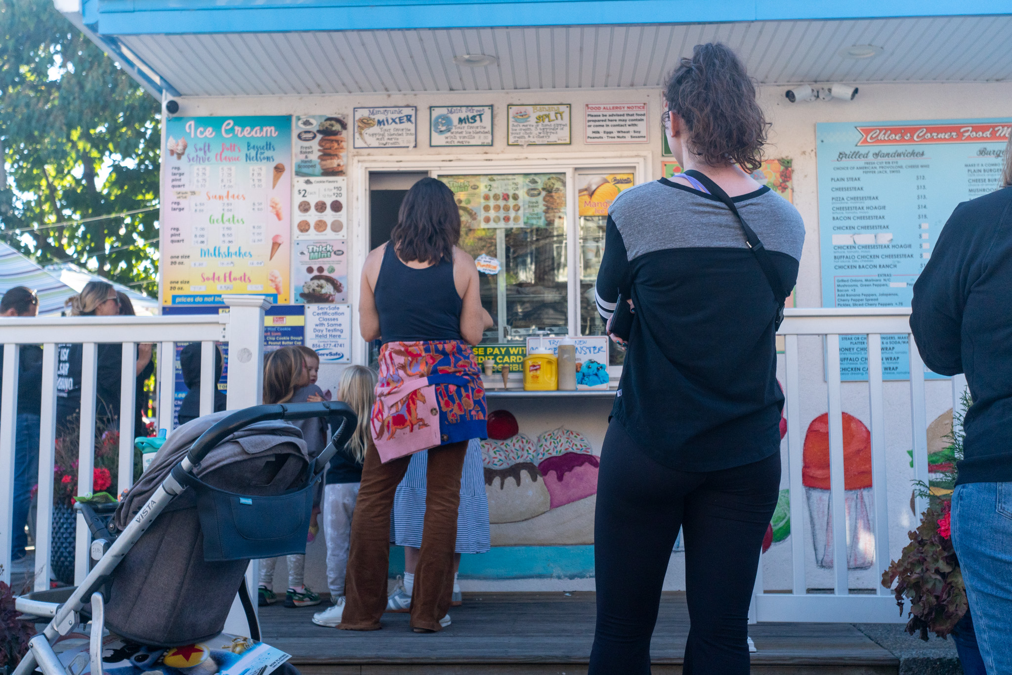 People lined up at Chloe’s Corner window for soft serve and Italian ice.