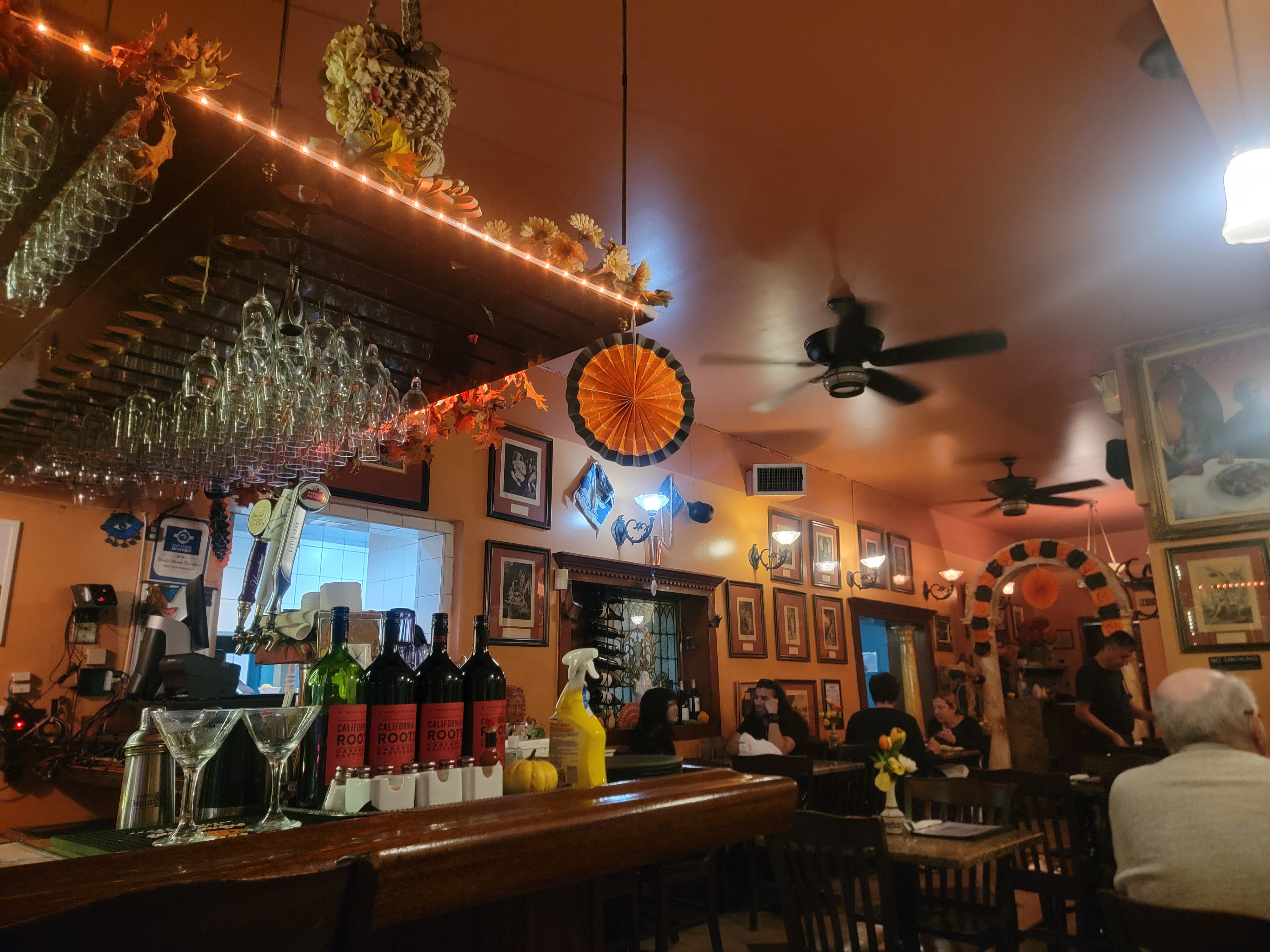Warm-lit Greek restaurant interior on South Street.